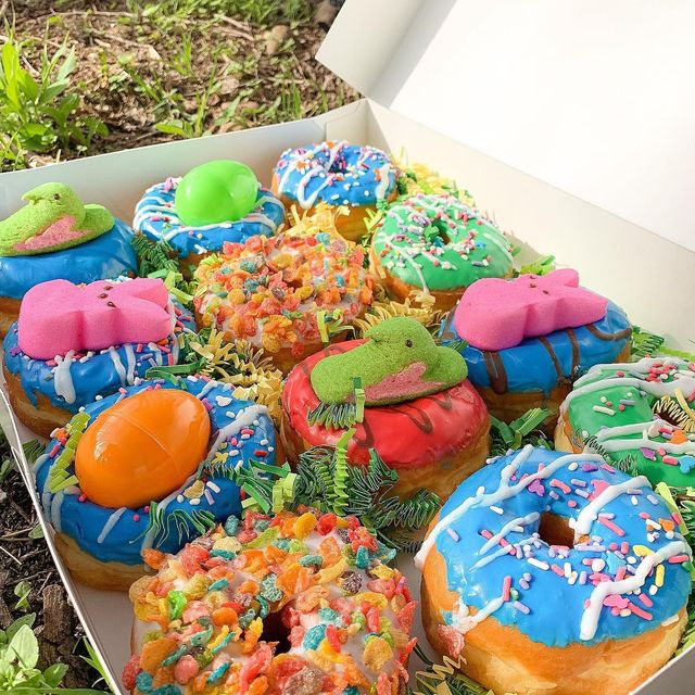 An Easter box of decorated donuts with pastel icing
