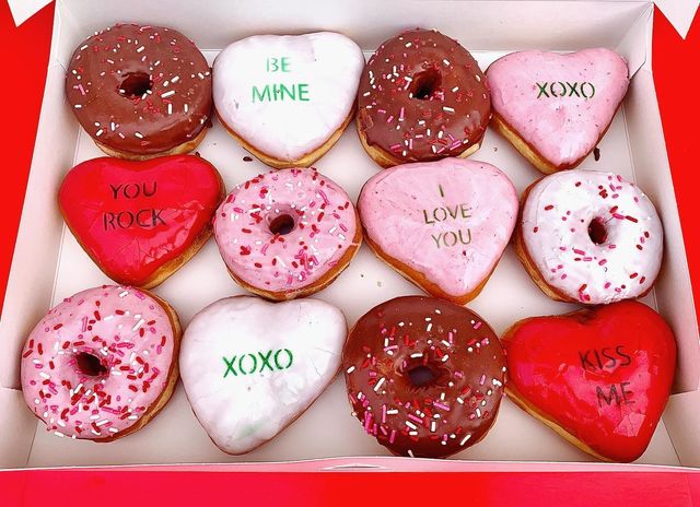 Valentine's heart-shaped donuts iced with BE MINE and XOXO