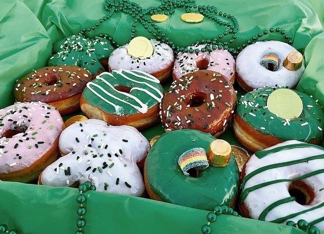 A St Patrick's Day box of green and gold decorated donuts